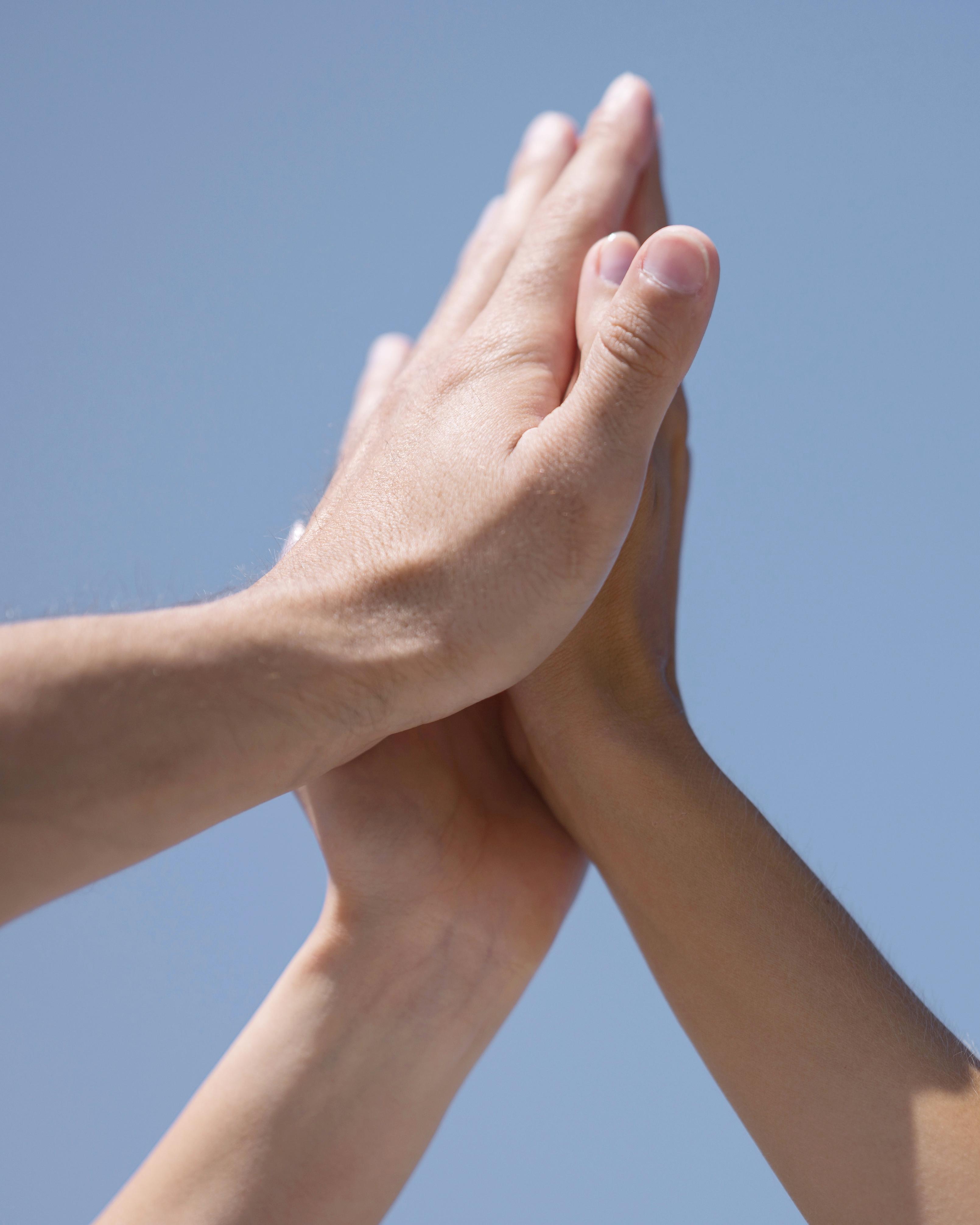 Friends High Fiving Outside After Coronavirus